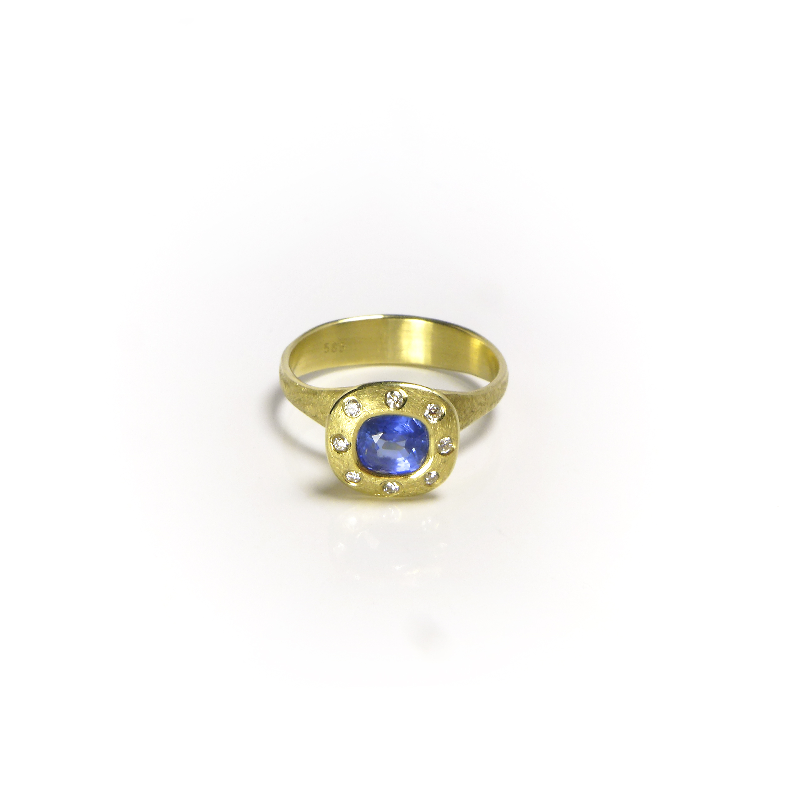 thick yellow gold ring with a big blue sapphire stone and eight small diamonds around